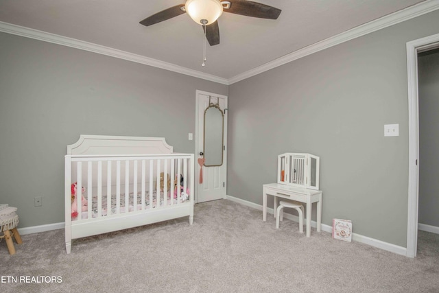 bedroom with light colored carpet, ornamental molding, a nursery area, and ceiling fan