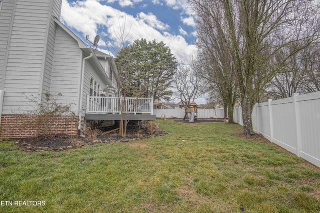 view of yard featuring a playground and a wooden deck