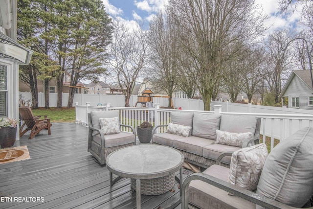 wooden deck with an outdoor hangout area and a playground