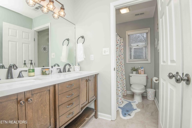 bathroom with vanity, tile patterned floors, and toilet