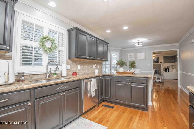 kitchen with dishwasher, sink, ornamental molding, and decorative backsplash