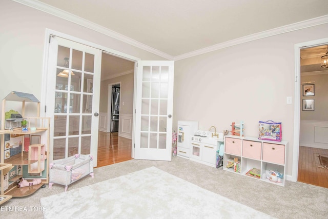 game room featuring crown molding, french doors, and carpet