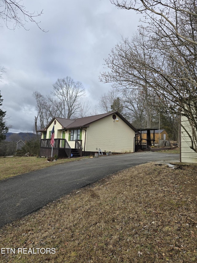 bungalow-style house featuring a wooden deck