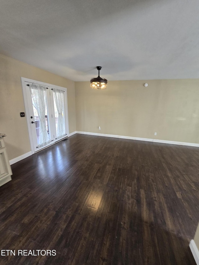 interior space featuring dark wood finished floors and baseboards