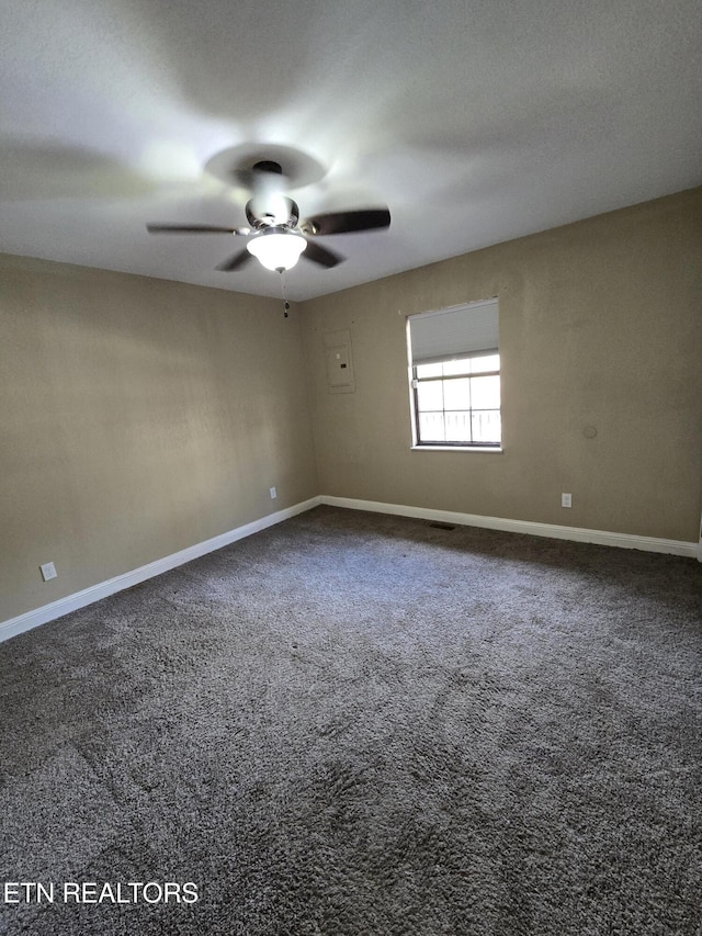 empty room with ceiling fan, carpet floors, and baseboards