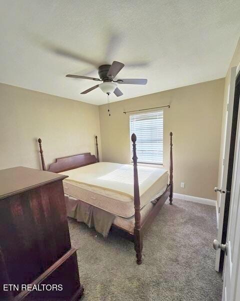 carpeted bedroom with a textured ceiling, ceiling fan, and baseboards