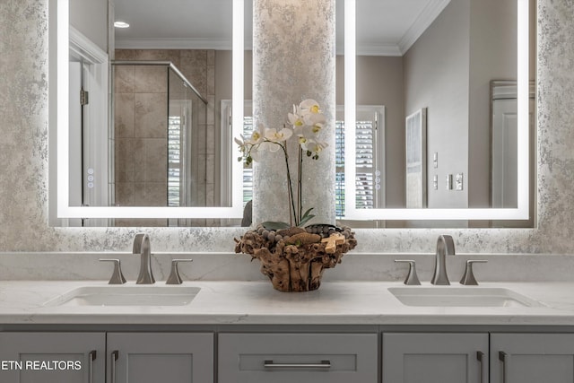 bathroom featuring vanity, a shower with door, and ornamental molding