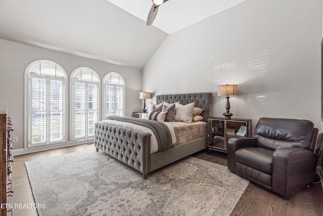 bedroom with hardwood / wood-style floors, vaulted ceiling, and ceiling fan