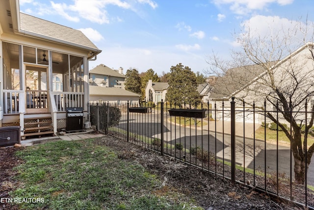 view of yard with central AC and a sunroom