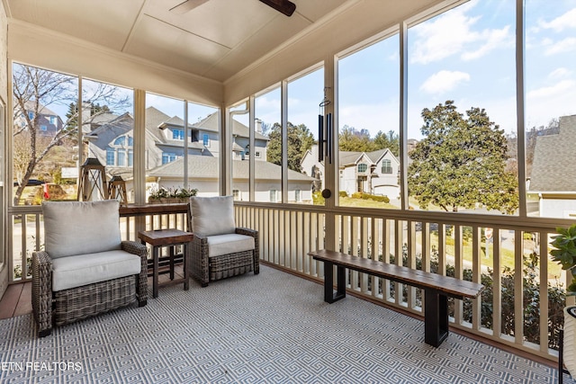 sunroom / solarium featuring ceiling fan