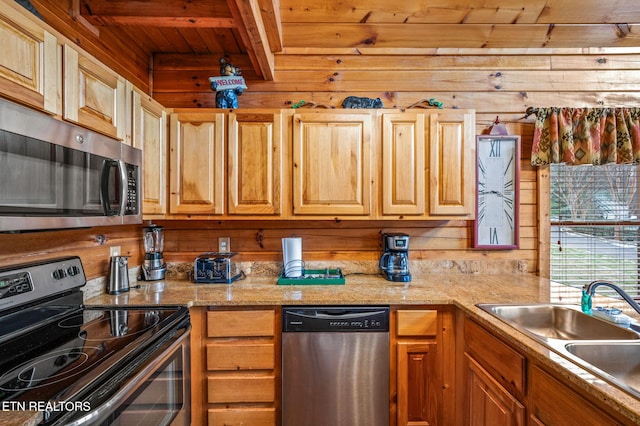 kitchen with wood walls, sink, stainless steel appliances, light stone countertops, and wooden ceiling