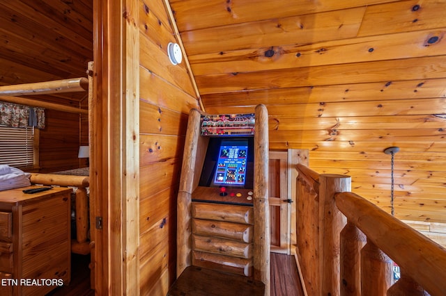 stairs featuring wood walls