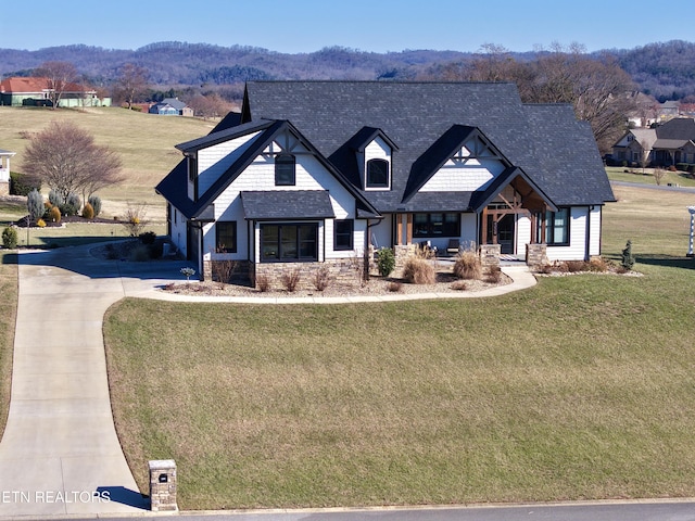 view of front facade featuring a mountain view and a front lawn