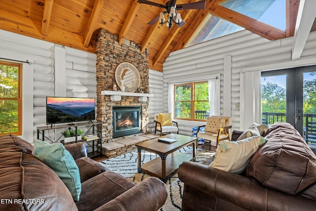 living area featuring high vaulted ceiling, a fireplace, wood finished floors, and beam ceiling