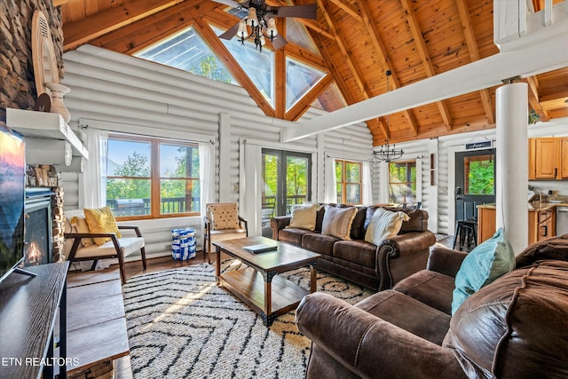 living area featuring log walls, a warm lit fireplace, a ceiling fan, wood ceiling, and wood finished floors