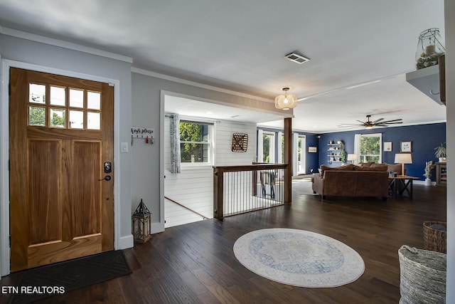 foyer with dark hardwood / wood-style flooring and ornamental molding