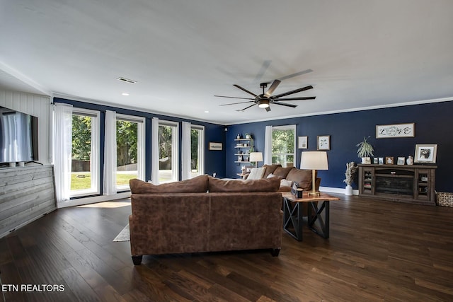 living room featuring crown molding, a healthy amount of sunlight, ceiling fan, and dark hardwood / wood-style floors