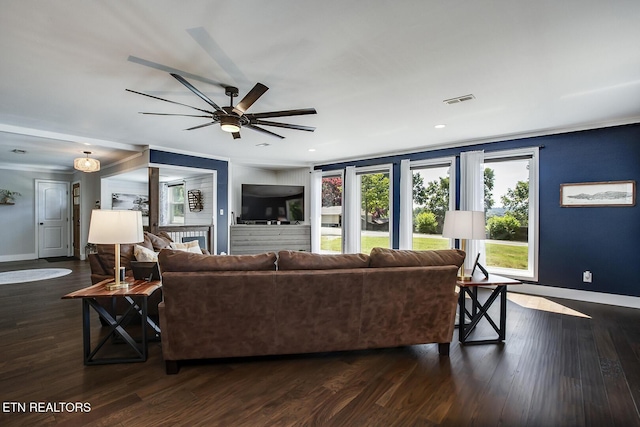 living room with crown molding, ceiling fan, and dark hardwood / wood-style flooring