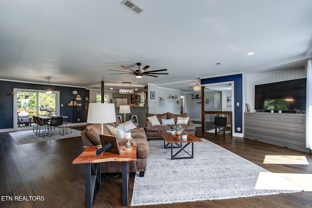 living room featuring ceiling fan, ornamental molding, and dark hardwood / wood-style floors