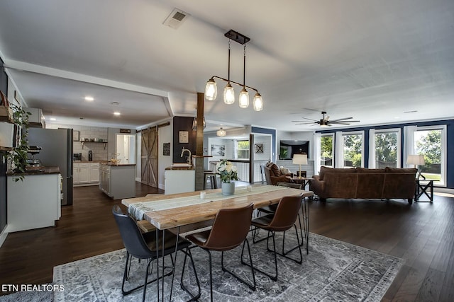 dining room featuring dark hardwood / wood-style floors and ceiling fan