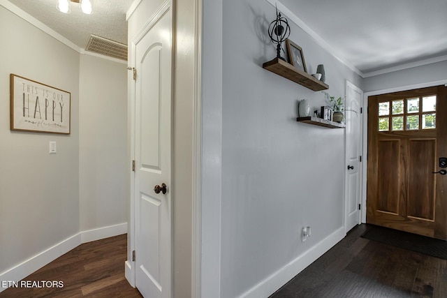 entrance foyer featuring crown molding, dark wood-type flooring, and a textured ceiling