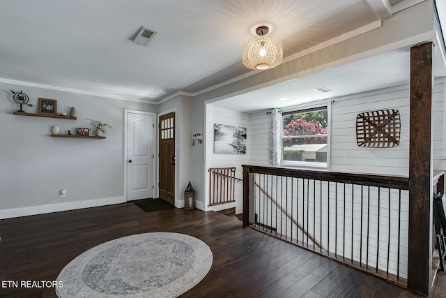 hall featuring dark wood-type flooring and ornamental molding