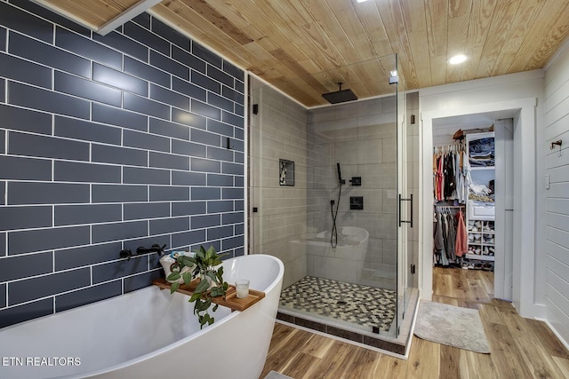 bathroom with shower with separate bathtub, hardwood / wood-style floors, and wood ceiling