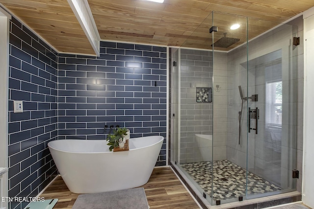 bathroom with independent shower and bath, hardwood / wood-style floors, tile walls, and wooden ceiling