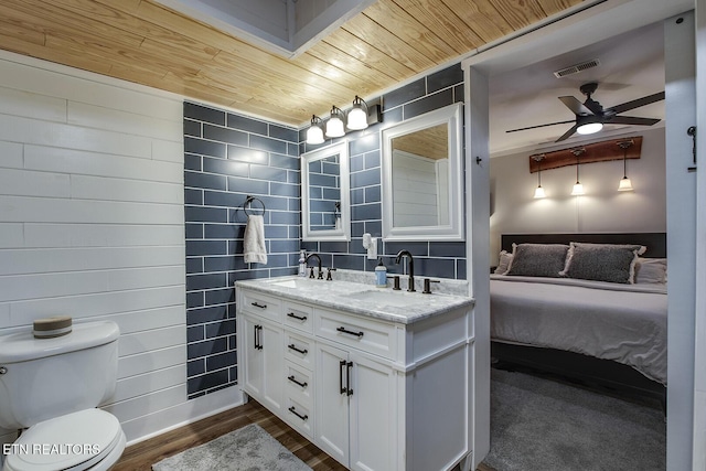 bathroom featuring toilet, wooden ceiling, vanity, hardwood / wood-style flooring, and ceiling fan