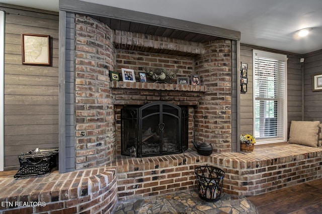 interior space featuring a brick fireplace and wood walls