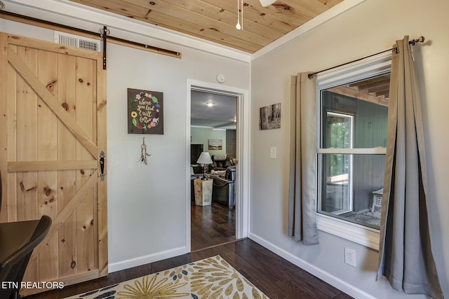 hall featuring wood ceiling, dark wood-type flooring, and a barn door