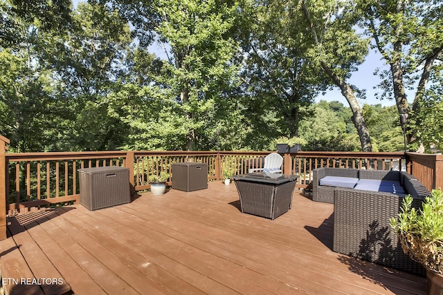 wooden terrace with an outdoor hangout area