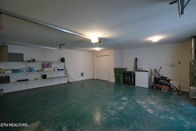 garage with washer / dryer and a garage door opener