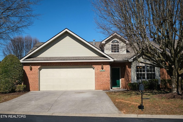 view of front of home with a garage, a shingled roof, concrete driveway, and brick siding