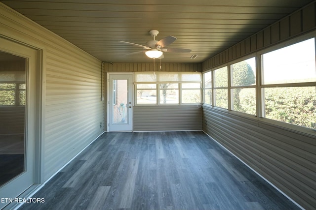 unfurnished sunroom featuring ceiling fan and a healthy amount of sunlight