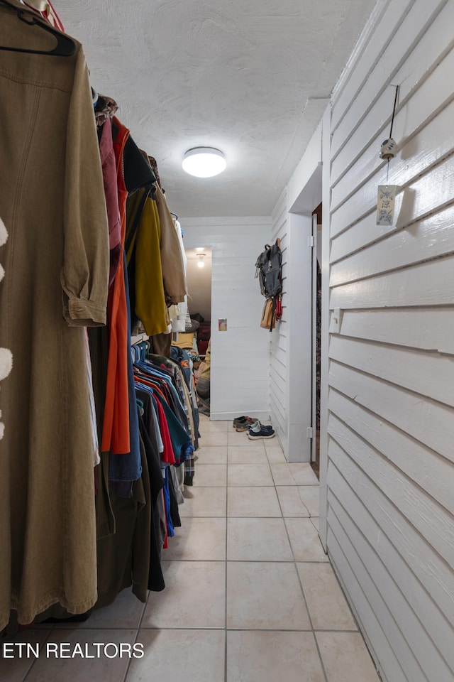 walk in closet featuring light tile patterned flooring