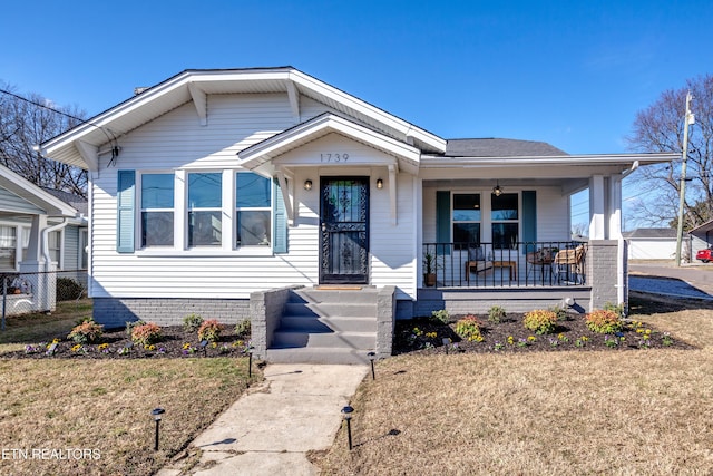 bungalow-style home featuring a front yard and a porch