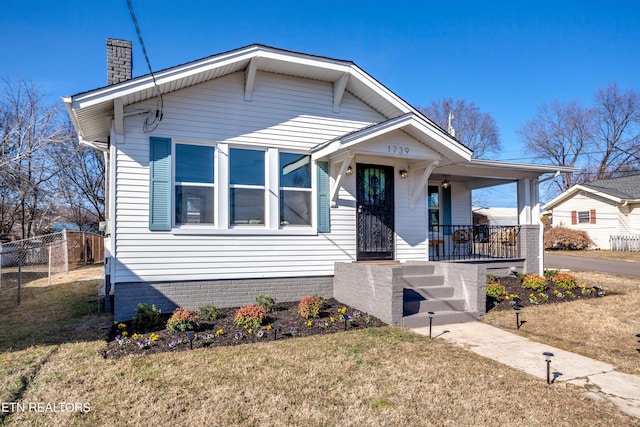 view of front of home featuring covered porch and a front lawn