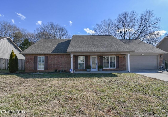 ranch-style home with a garage and a front lawn