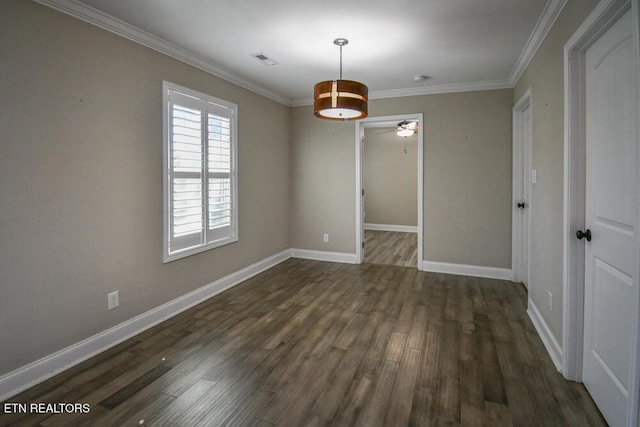 spare room featuring dark wood-type flooring, ornamental molding, and ceiling fan