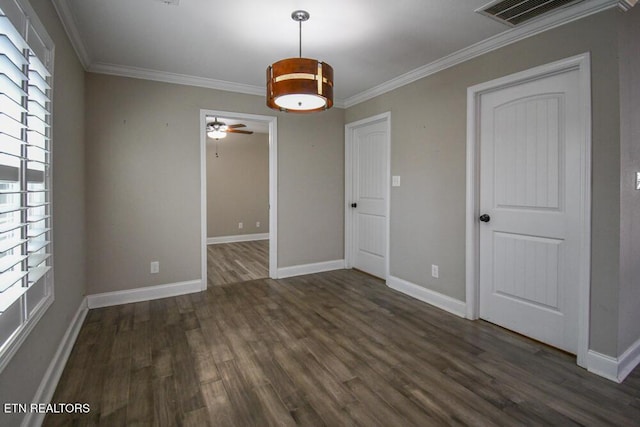 empty room with ornamental molding, dark hardwood / wood-style floors, and ceiling fan