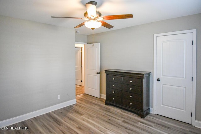 unfurnished bedroom with ceiling fan and light hardwood / wood-style floors