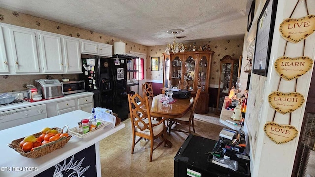 interior space with black refrigerator with ice dispenser, hanging light fixtures, a textured ceiling, dishwasher, and white cabinets