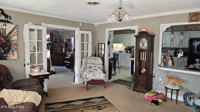 interior space featuring crown molding, carpet floors, a textured ceiling, and a notable chandelier