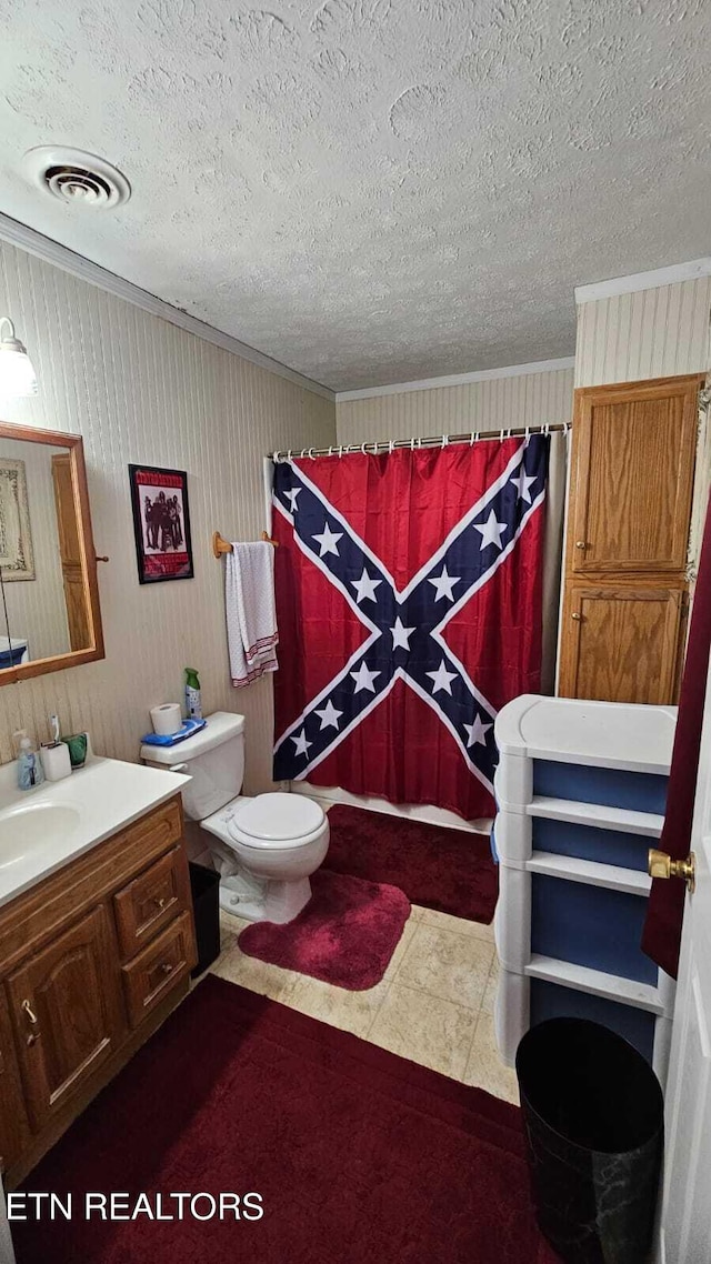 bathroom featuring crown molding, vanity, a textured ceiling, and toilet