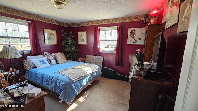 bedroom with carpet floors and a textured ceiling