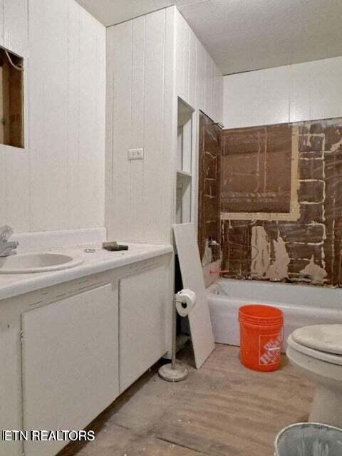 bathroom featuring hardwood / wood-style flooring, vanity, and toilet