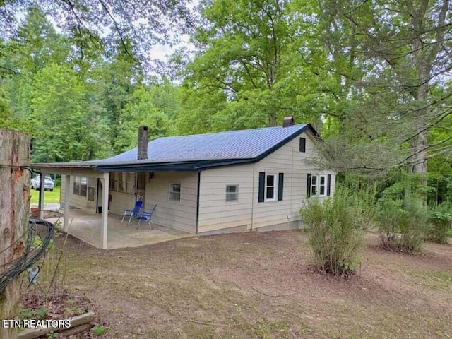 rear view of house featuring a patio