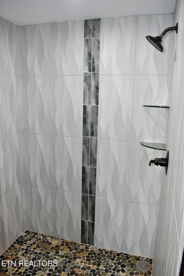 bathroom with a tile shower