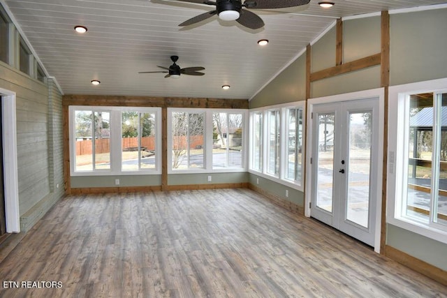 unfurnished sunroom featuring lofted ceiling, wood ceiling, french doors, and ceiling fan